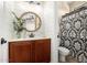 Contemporary bathroom with a decorative mirror, shiplap wall, and a shower with patterned curtain at 530 S Emerson St, Chandler, AZ 85225