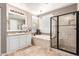 Bright bathroom with a soaking tub, a glass enclosed shower and tiled floor at 530 S Emerson St, Chandler, AZ 85225