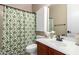 This charming bathroom showcases a green and white patterned shower curtain and a classic vanity at 530 S Emerson St, Chandler, AZ 85225