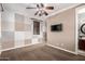 Cozy bedroom features unique square paneled wall design, a ceiling fan, and an ensuite bathroom entrance at 530 S Emerson St, Chandler, AZ 85225