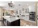 Spacious kitchen featuring a central island, stainless steel appliances, and white cabinetry at 530 S Emerson St, Chandler, AZ 85225