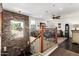 This open living space features a stone accent wall, wood floors, and a chandelier at 530 S Emerson St, Chandler, AZ 85225