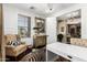 Charming home office features a decorative chair, artwork, and a view into the next room at 530 S Emerson St, Chandler, AZ 85225