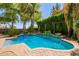 Backyard pool and patio with decorative pergola and lush landscaping at 530 S Emerson St, Chandler, AZ 85225