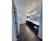 Spacious bathroom featuring dual sinks, dark cabinetry, a large mirror, and tiled floors at 5306 N 188Th Ln, Litchfield Park, AZ 85340