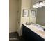Bathroom with dark vanity, large mirror, and decorative artwork for added character at 5306 N 188Th Ln, Litchfield Park, AZ 85340
