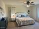 Serene bedroom with a tufted headboard, neutral tones, and modern bedside lamps at 5306 N 188Th Ln, Litchfield Park, AZ 85340