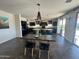 Open-concept dining area with modern chandelier and seamless flow to the kitchen at 5306 N 188Th Ln, Litchfield Park, AZ 85340