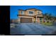 Charming two-story home featuring a two-car garage and well-maintained front yard at 5306 N 188Th Ln, Litchfield Park, AZ 85340