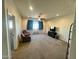 Large living room with carpet, ceiling fan, media center, and comfortable seating in a well-lit space at 5306 N 188Th Ln, Litchfield Park, AZ 85340