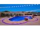 Inviting pool area featuring an elegant stone border, water feature, and mountain views at 5306 N 188Th Ln, Litchfield Park, AZ 85340