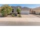 Charming home with a two-car garage, desert landscaping, and a paved driveway at 549 E Balao Dr, Phoenix, AZ 85085