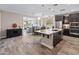 Open-concept kitchen featuring a spacious island, stainless steel appliances, and dark wood cabinetry at 549 E Balao Dr, Phoenix, AZ 85085