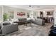 Contemporary living room with gray sofas, a ceiling fan, and desert-themed artwork at 549 E Balao Dr, Phoenix, AZ 85085