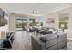 Spacious living room with gray sofas, modern decor, and an access to the pool at 549 E Balao Dr, Phoenix, AZ 85085