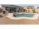 Inviting backyard pool area with a tanning deck, patio seating, awning, and well-maintained landscaping at 549 E Balao Dr, Phoenix, AZ 85085