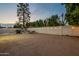 Expansive backyard featuring a dining set, barbecue grill, and ambient string lights for evening enjoyment at 6216 W Poinsettia Dr, Glendale, AZ 85304