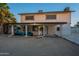 Spacious backyard with patio furniture, grill, and a partial view of the two-story home, perfect for outdoor entertaining at 6216 W Poinsettia Dr, Glendale, AZ 85304