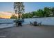 Backyard featuring a grill, seating area, string lights and green trees, offering a relaxing outdoor experience at 6216 W Poinsettia Dr, Glendale, AZ 85304