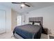 Cozy bedroom featuring a ceiling fan, comfortable queen bed, and neutral decor at 6216 W Poinsettia Dr, Glendale, AZ 85304