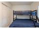 Bedroom featuring a bunk bed, a closet and blue beddings at 6216 W Poinsettia Dr, Glendale, AZ 85304