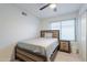 Cozy bedroom showcases a modern bed frame, natural light, and tile flooring at 6216 W Poinsettia Dr, Glendale, AZ 85304