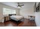 Bedroom offers wood floors, bright lighting, and a wall-mounted television at 6216 W Poinsettia Dr, Glendale, AZ 85304
