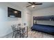 Bedroom featuring a bunk bed, a flat-screen TV, a ceiling fan, and a small dining table at 6216 W Poinsettia Dr, Glendale, AZ 85304