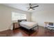Bedroom features wood floors and a window offering plenty of natural lighting at 6216 W Poinsettia Dr, Glendale, AZ 85304