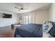 Spacious bedroom with dark wood flooring, a ceiling fan, and access to a private balcony at 6216 W Poinsettia Dr, Glendale, AZ 85304