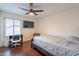 Bedroom showcases wood floors, bright lighting, and a ceiling fan at 6216 W Poinsettia Dr, Glendale, AZ 85304