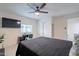 Comfortable bedroom featuring a large television, workspace, and view of the window at 6216 W Poinsettia Dr, Glendale, AZ 85304
