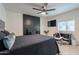 Cozy bedroom featuring a fireplace and a dedicated desk area with tile flooring at 6216 W Poinsettia Dr, Glendale, AZ 85304