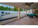 Enjoy this covered patio featuring tiled flooring, ceiling fans, and plush outdoor seating, ideal for entertaining at 6216 W Poinsettia Dr, Glendale, AZ 85304