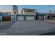 Inviting two-story home with a three-car garage, upper balcony, and solar panels, offering modern living at 6216 W Poinsettia Dr, Glendale, AZ 85304
