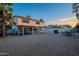The house exterior is complemented by a spacious backyard, featuring a patio, dining area, and a grill at 6216 W Poinsettia Dr, Glendale, AZ 85304