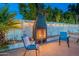 Cozy outdoor fireplace perfect for gatherings in the landscaped backyard at 6216 W Poinsettia Dr, Glendale, AZ 85304