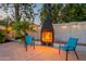 Charming backyard brick fireplace with seating, perfect for outdoor gatherings and cozy evenings at 6216 W Poinsettia Dr, Glendale, AZ 85304