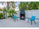 Outdoor fireplace on the patio provides a cozy gathering spot with comfortable chairs for relaxing evenings at 6216 W Poinsettia Dr, Glendale, AZ 85304