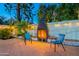 Outdoor fireplace area with string lights and seating for relaxing evenings at 6216 W Poinsettia Dr, Glendale, AZ 85304