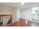 Spacious hallway with wood floors leading to the bathroom and a staircase at 6216 W Poinsettia Dr, Glendale, AZ 85304