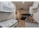 A kitchen and living area including an oven, microwave, bunkbed, ceiling fan, and dining table at 6216 W Poinsettia Dr, Glendale, AZ 85304