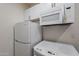 A kitchen including a white refrigerator, oven, microwave, and cabinets against a white wall at 6216 W Poinsettia Dr, Glendale, AZ 85304