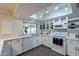 Bright kitchen with skylight, quartz countertops, stainless appliances, and lots of cabinet space at 6216 W Poinsettia Dr, Glendale, AZ 85304