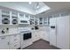 Bright kitchen featuring quartz countertops, stainless appliances, and ample counter space at 6216 W Poinsettia Dr, Glendale, AZ 85304