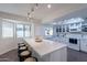 Bright kitchen featuring quartz countertops, a breakfast bar, and lots of cabinet space at 6216 W Poinsettia Dr, Glendale, AZ 85304