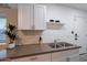 Modern kitchenette featuring white cabinets, countertop, and a plant at 6216 W Poinsettia Dr, Glendale, AZ 85304