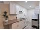 Modern kitchenette featuring white cabinets, countertop, and appliances at 6216 W Poinsettia Dr, Glendale, AZ 85304