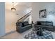 Inviting living room displaying grey sofas, vaulted ceilings, tile floors, and ample natural light at 6216 W Poinsettia Dr, Glendale, AZ 85304