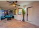 Covered patio featuring tile flooring, comfortable seating, and views of the landscaped backyard at 6216 W Poinsettia Dr, Glendale, AZ 85304
